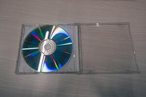 Stack of compact disks on a wooden table. Vcd, blueray photo