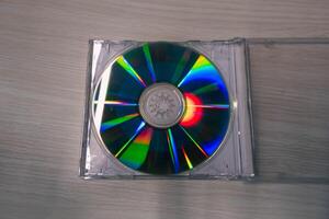 Stack of compact disks on a wooden table. Vcd, blueray photo