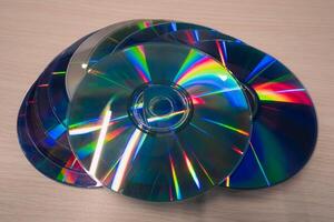 Stack of compact disks on a wooden table. Vcd, blueray photo