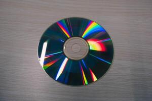 Stack of compact disks on a wooden table. Vcd, blueray photo