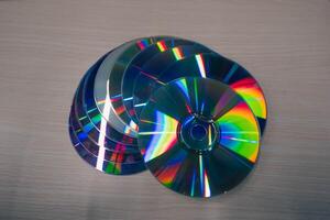 Stack of compact disks on a wooden table. Vcd, blueray photo
