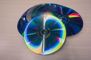 Stack of compact disks on a wooden table. Vcd, blueray photo