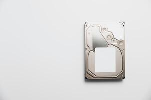 Disassembled interior of a hard drive, which is the computer's storage device. Broken hard drive on white background photo