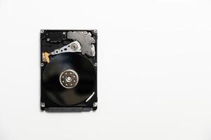 White background on which lies a sleek hard drive, combining modernity and simplicity in a technologically minimalist aesthetic. photo