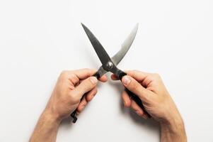 Worker holding pruning shears by handles on white background, close-up. Garden tool photo