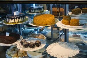 Assortment of Cakes and Pastries in a Bakery Display Case photo