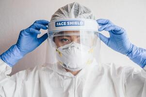 Healthcare worker wearing PPE suit for working in hospital during Covid-19 pandemic outbreak. PPE is equipment that will protect the user against health or safety risks at work. photo