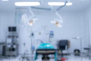 Blurred image background of operating room in hospital. An operating room may be designed and equipped to provide care to patients. photo
