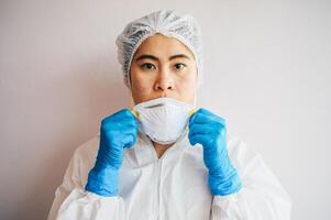Healthcare worker with acne and facial wounds occur from a medical mask after work for a long time in hospital during covid-19 pandemic. Wearing mask for prolonged periods can damage the skin. photo