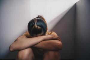 Portrait of sadness or depressed woman crying after failure and layoff from work because impact from covid-19 pandemic outbreak. Conceptual of unemployed woman having negative feelings. photo