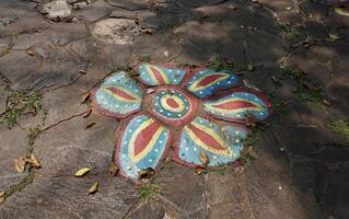 Stone rock outdoor ground flooring with abstract flower petal painting on the surface isolated on horizontal ratio background. photo