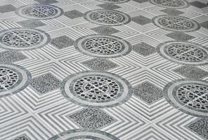 Gray ceramic floor tiles with stone pattern texture design isolated on horizontal ratio background. photo