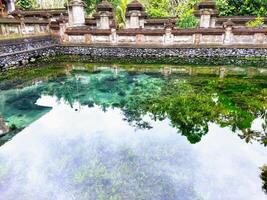 Pura Tirta Empul - Hindu Balinese temple with a bathing area containing holy spring water for ritual purification photo