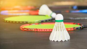 Badminton shuttlecocks with rackets on a dark background symbolizing the spirit of exercise and global competition the essence of athleticism and the pursuit of excellence in the sport. photo