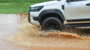 Floodwater splashing violently caused by a vehicle which is driven through. photo