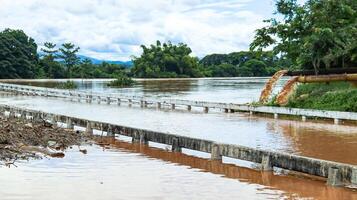 An image of a concrete bridge submerged in floodwater. photo
