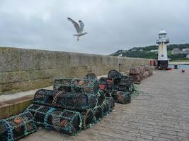 pier with lighthouse, fish traps and flying seagull photo