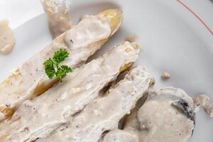 white asparagus in cream sauce fresh meal food snack on the table copy space food background rustic top view photo