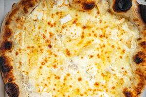 pizza four types of cheese mozzarella, blue cheese, camembert and cheddar fresh meal food snack on the table copy space food background rustic top view photo