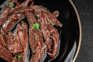 anchovies in a plate on the table canned fish in oil fresh and tasty seafood meal food snack on the table copy space food background rustic photo