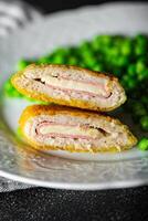 cutlet cordon bleu chicken meat, cheese, bacon meal snack on the table copy space food background rustic top view photo