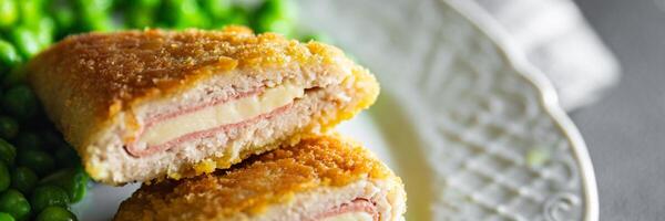 cutlet cordon bleu chicken meat, cheese, bacon meal snack on the table copy space food background rustic top view photo