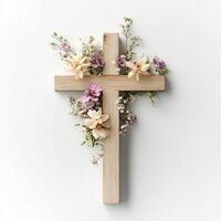 Wooden cross adorned with delicate flowers on a minimalist white background photo