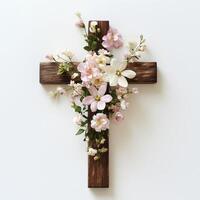 Dark wooden cross decorated with soft pastel flowers on a clean white background photo