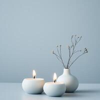 Minimalist still life with round candles and a simple vase with delicate branches on a light background photo