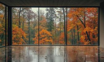 Minimalist room with panoramic window and rainy autumn landscape view outside photo