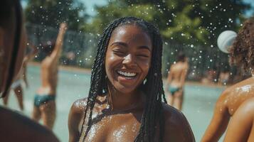 A woman is smiling while standing in a pool with other people photo