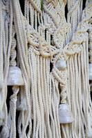 Macram weaving. Light thread with large beads. Near. Boho style photo