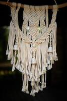 Macram weaving. Light thread with large beads. Near. Boho style photo