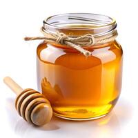 Jar of honey and dipper. A jar of honey on a white background. photo