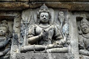 Relief and statue of gods at Prambanan temple, Central Java - Indonesia photo