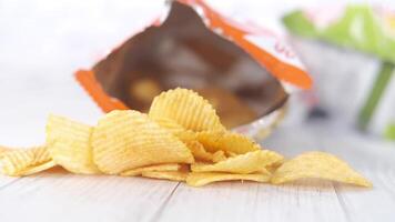 A bag of chips on a table with a packet of chips video