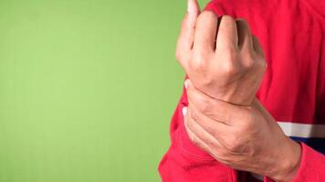 A person with a hand in pain on a green background video