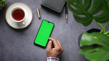 Man using smartphone with green screen on concrete background video