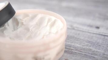 A close up of a jar of cream on a wooden surface video