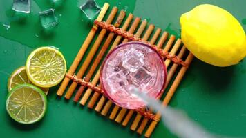 A glass of lemonade with a straw and a lemon slice video