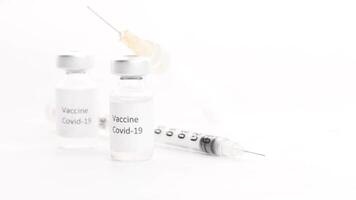 Vaccine and syringe on white background video