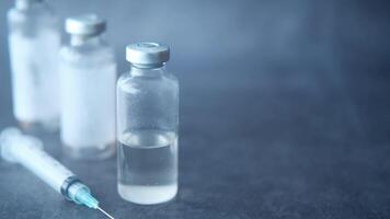 Vaccine and syringe on a table video