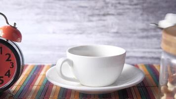 A cup of coffee and a clock on a table video