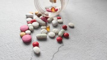 Pills spilling out of a bottle on a table video