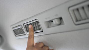 A person touching a vent on a car video