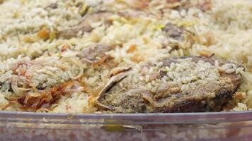 A dish of rice and meat in a clear container video