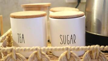 A wicker basket with tea and sugar jars for a charming tea event video