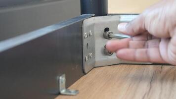 Using a wrench, theyre removing a screw from metal video