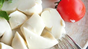 A beautiful plate is arranged with Fresh Mozzarella and vibrant, ripe Tomato for enjoyment video