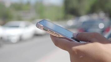 An individual uses a smartphone while walking through a busy urban area, navigating carefully video